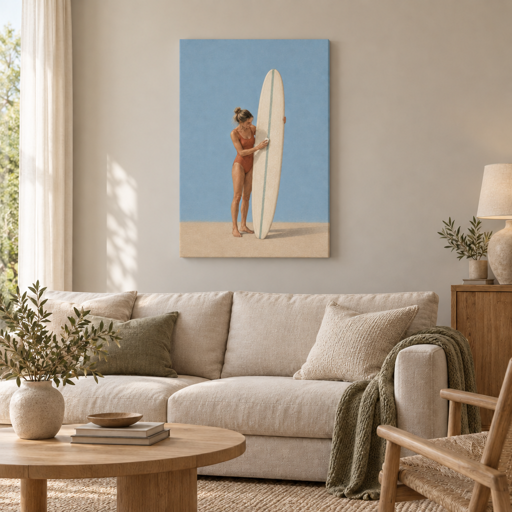 Vor der ersten Welle – Surferin Wandbild als rahmenlose Slim-Leinwand über einem cremefarbenen Sofa im Wohnzimmer.